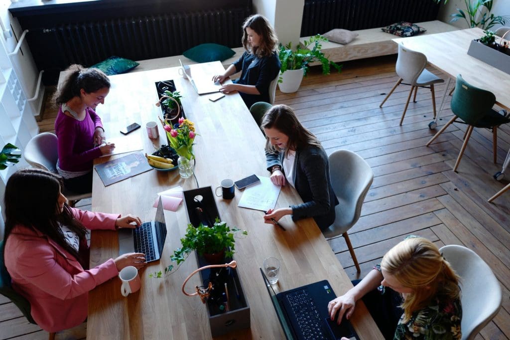 an overhead photo of a group of people coworking in a nice space
