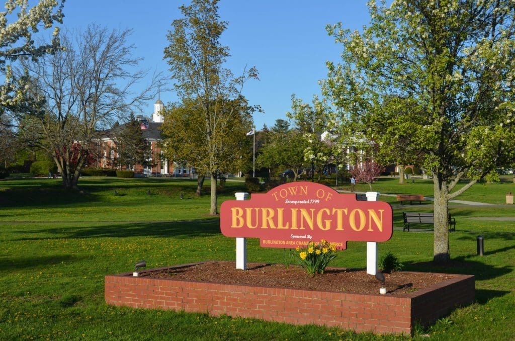 photo of the Town of Burlington sign that's in gold lettering against the red background of the wooden sign